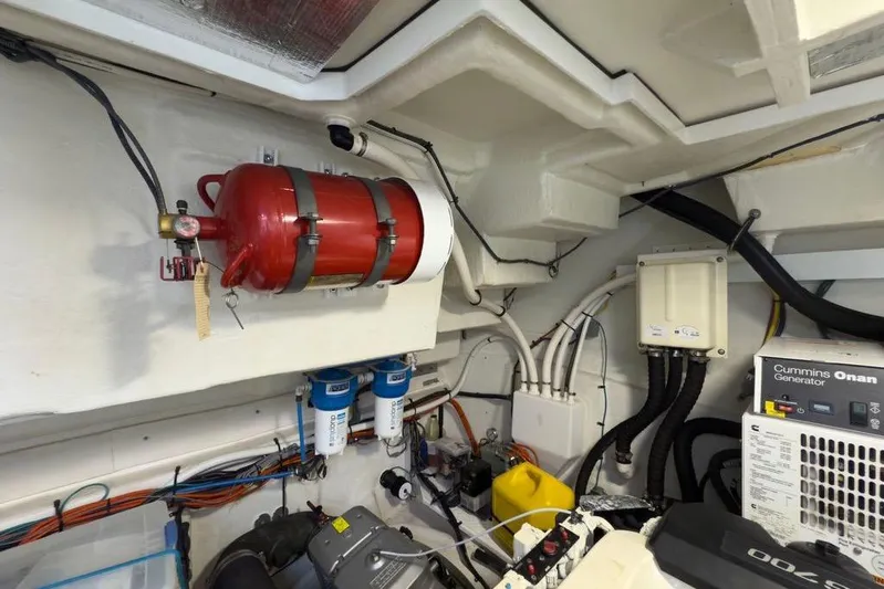  Yacht Photos Pics Engine room of 2020 Cruisers Yachts 50 Cantius with fire extinguisher and Cummins Onan generator.