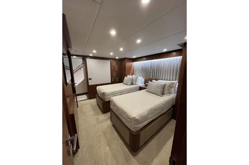 Congvoyage Yacht Photos Pics Luxurious twin bedroom in 2020 Hargrave G120 yacht, featuring elegant wood paneling and soft lighting.