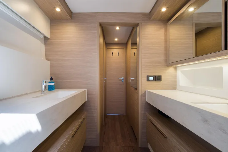 Catwalk Yacht Photos Pics Modern bathroom interior of 2023 Lagoon LAGOON 51 yacht, featuring sleek design and ambient lighting.