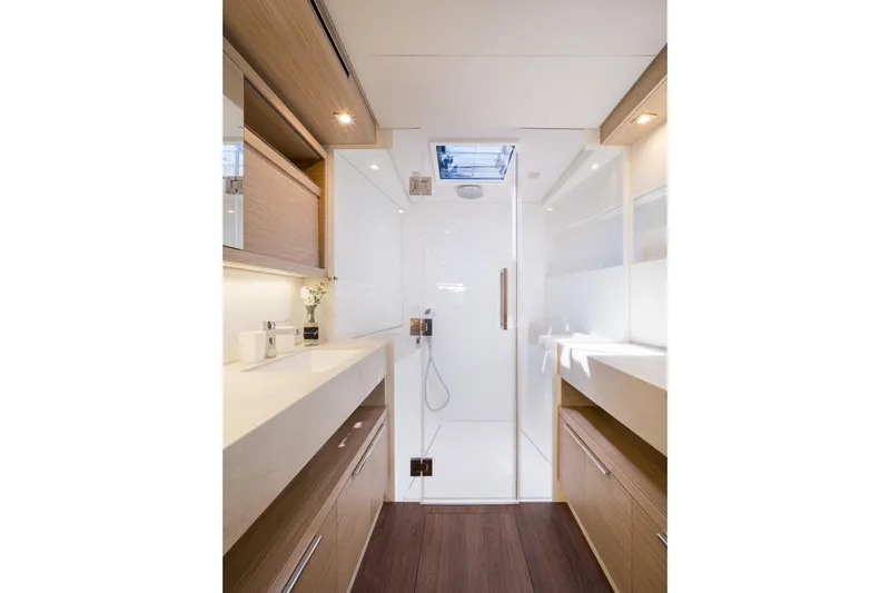 Catwalk Yacht Photos Pics Luxurious bathroom interior of 2023 Lagoon LAGOON 51 yacht with modern fixtures.