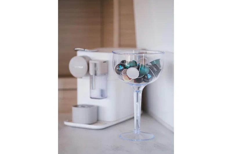 Catwalk Yacht Photos Pics Coffee machine with capsules in a glass, onboard Lagoon 51 yacht, 2023 model.