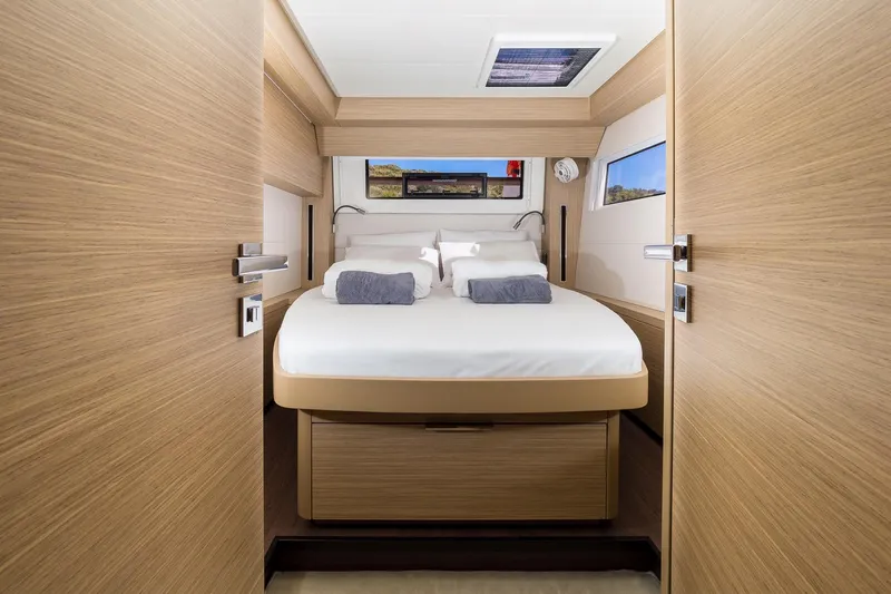 Catwalk Yacht Photos Pics Luxurious cabin interior of 2023 Lagoon LAGOON 51 yacht with modern wood finish.