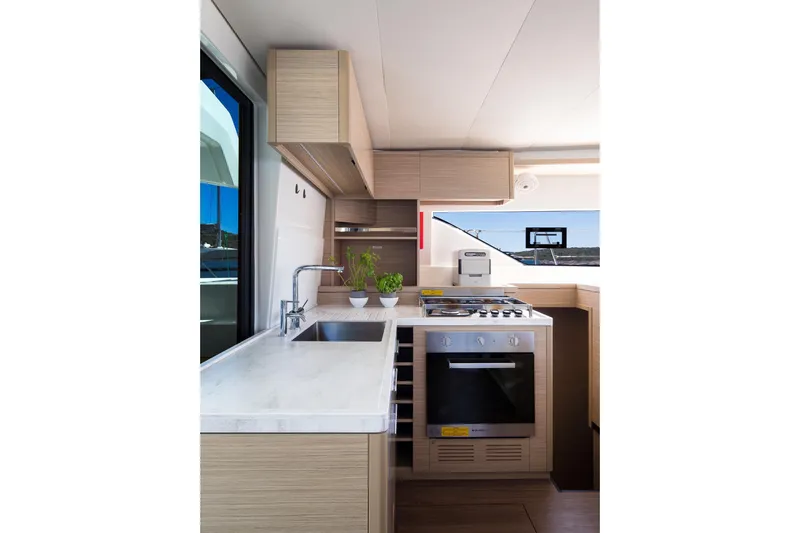 Catwalk Yacht Photos Pics Modern kitchen interior of 2023 Lagoon LAGOON 51 yacht with sleek design and appliances.