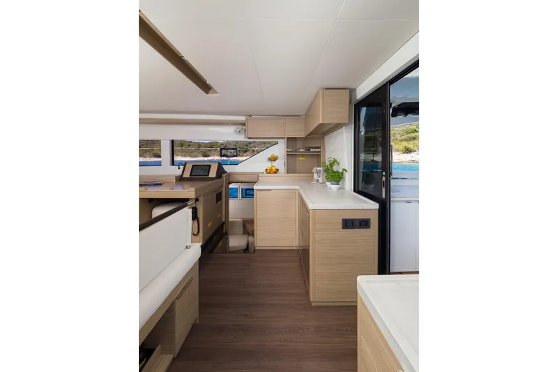 Catwalk Yacht Photos Pics Modern interior of 2023 Lagoon 51 yacht with sleek wood finishes and ocean view.