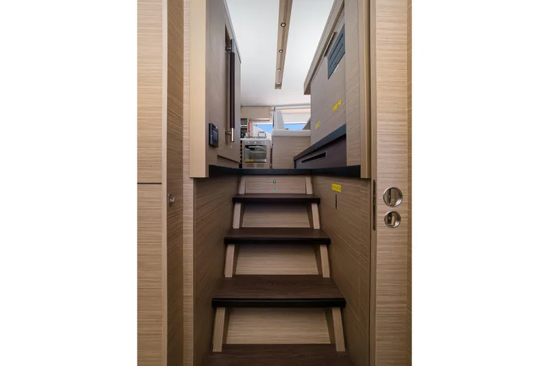 Catwalk Yacht Photos Pics Interior stairs of 2023 Lagoon LAGOON 51 yacht, featuring modern wood design.