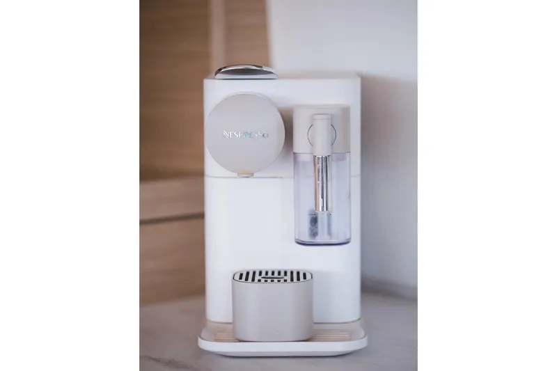 Catwalk Yacht Photos Pics Modern white Nespresso coffee machine on a kitchen counter, 2023 Lagoon 51 model.