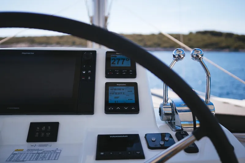 Catwalk Yacht Photos Pics Helm of 2023 Lagoon LAGOON 51 yacht with navigation instruments and controls.