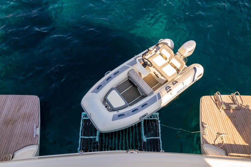 Catwalk Yacht Photos Pics Aerial view of a 2023 Lagoon LAGOON 51 yacht with a tender boat.