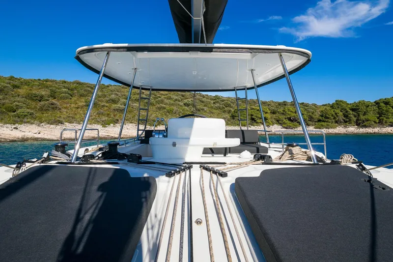 Catwalk Yacht Photos Pics 2023 Lagoon LAGOON 51 yacht deck with scenic coastal backdrop.