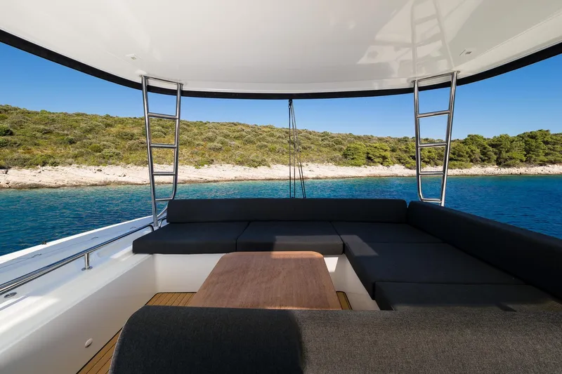 Catwalk Yacht Photos Pics Luxurious seating area on 2023 Lagoon LAGOON 51 yacht with scenic ocean view.