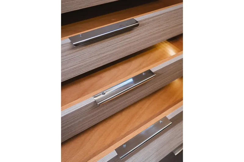 Catwalk Yacht Photos Pics Wooden drawers with sleek metal handles on the 2023 Lagoon LAGOON 51 yacht.