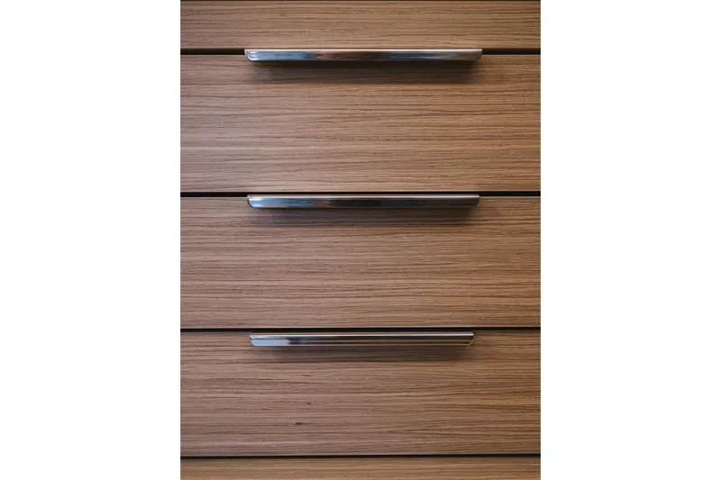 Catwalk Yacht Photos Pics Wooden cabinet drawers with sleek metal handles, part of the 2023 Lagoon LAGOON 51 model.
