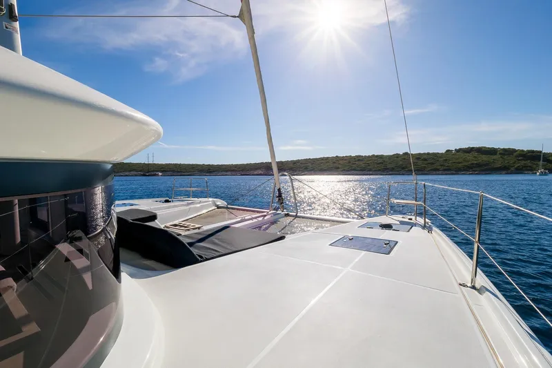 Catwalk Yacht Photos Pics 2023 Lagoon LAGOON 51 yacht on sunny sea, showcasing sleek deck design.