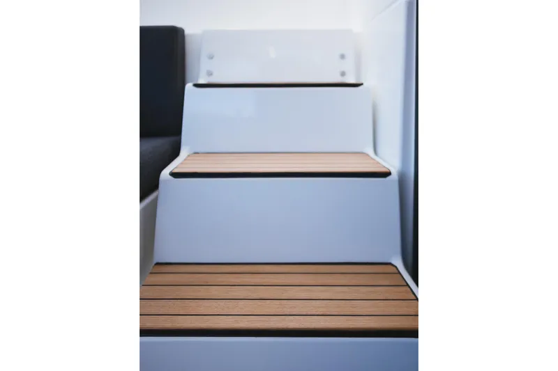 Catwalk Yacht Photos Pics Wooden steps on a 2023 Lagoon LAGOON 51 yacht interior staircase.