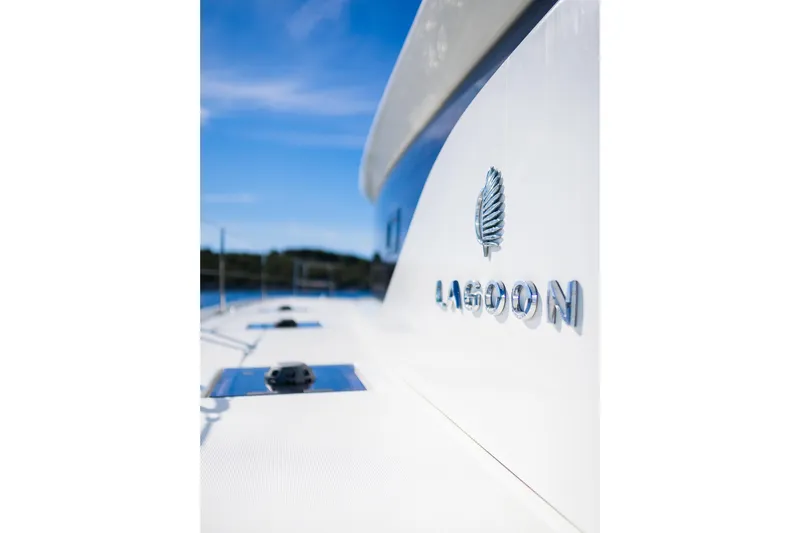 Catwalk Yacht Photos Pics 2023 Lagoon 51 yacht exterior with logo, under clear blue sky.