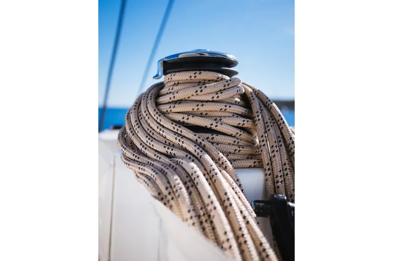 Catwalk Yacht Photos Pics Close-up of coiled rope on Lagoon 51 yacht, 2023 model, against a clear blue sky.