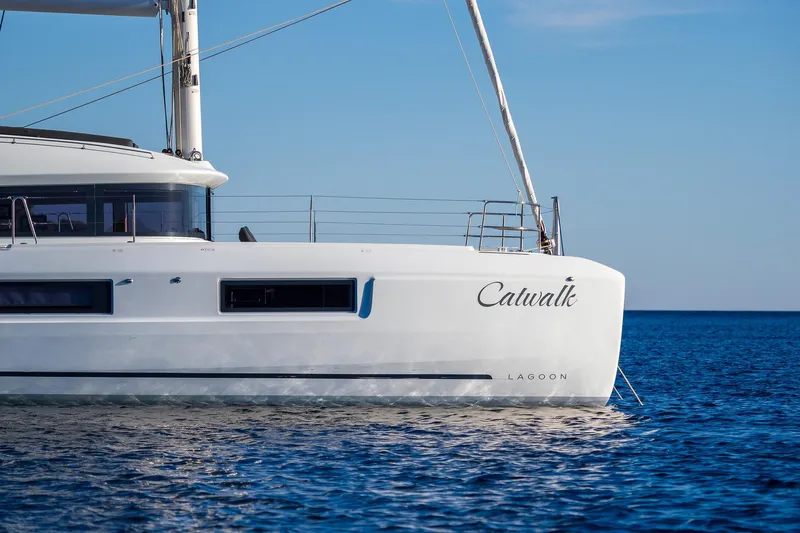 Catwalk Yacht Photos Pics 2023 Lagoon LAGOON 51 catamaran sailing on calm blue sea.