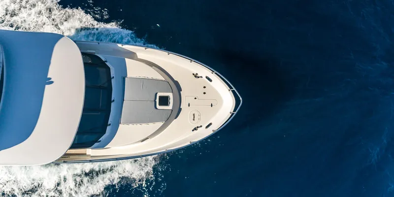 Uncorked Yacht Photos Pics Aerial view of 2011 Ocean Alexander 85E yacht cruising on deep blue water.