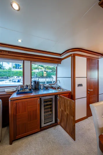 Uncorked Yacht Photos Pics Luxurious interior of 2011 Ocean Alexander 85E yacht with kitchenette and wine cooler.