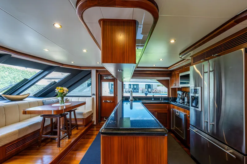 Uncorked Yacht Photos Pics Luxurious kitchen interior of 2011 Ocean Alexander 85E yacht with modern appliances and wood finishes.