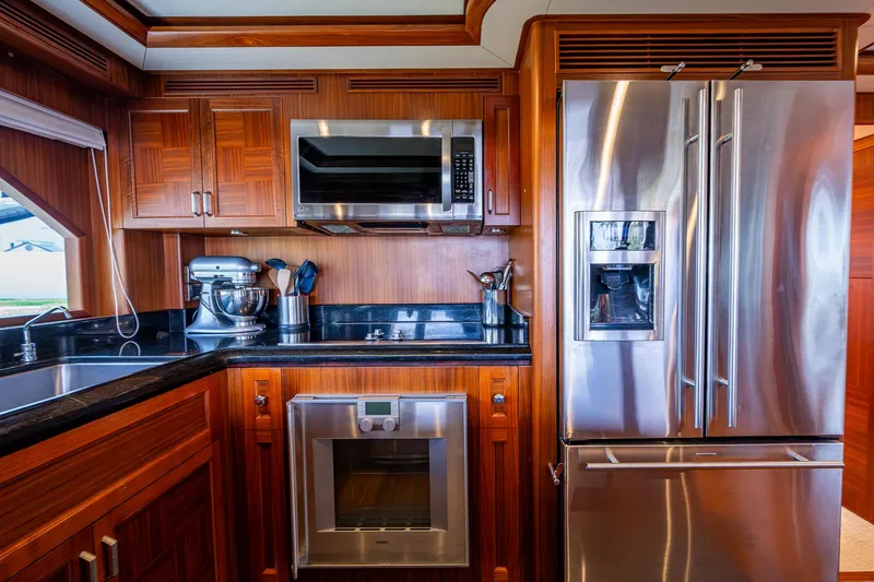 Uncorked Yacht Photos Pics Luxurious kitchen in 2011 Ocean Alexander 85E yacht with stainless steel appliances and wooden cabinetry.