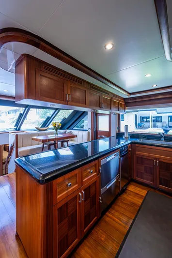 Uncorked Yacht Photos Pics Luxurious kitchen interior of 2011 Ocean Alexander 85E yacht with wood cabinetry and modern appliances.