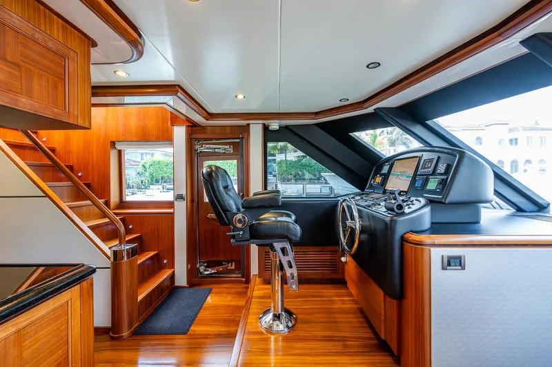 Uncorked Yacht Photos Pics Luxurious helm of 2011 Ocean Alexander 85E yacht with polished wood and modern controls.