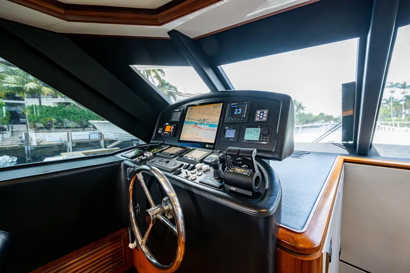 Uncorked Yacht Photos Pics Helm of 2011 Ocean Alexander 85E yacht with navigation screens and steering wheel.