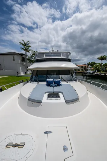 Uncorked Yacht Photos Pics Ocean Alexander 85E 2011 yacht with spacious deck under cloudy sky.