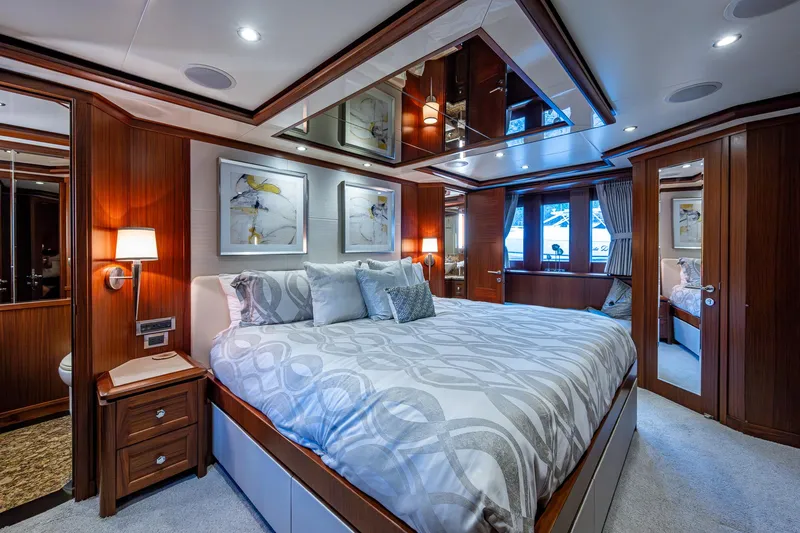 Uncorked Yacht Photos Pics Luxurious bedroom interior on 2011 Ocean Alexander 85E yacht with elegant wood finishes.