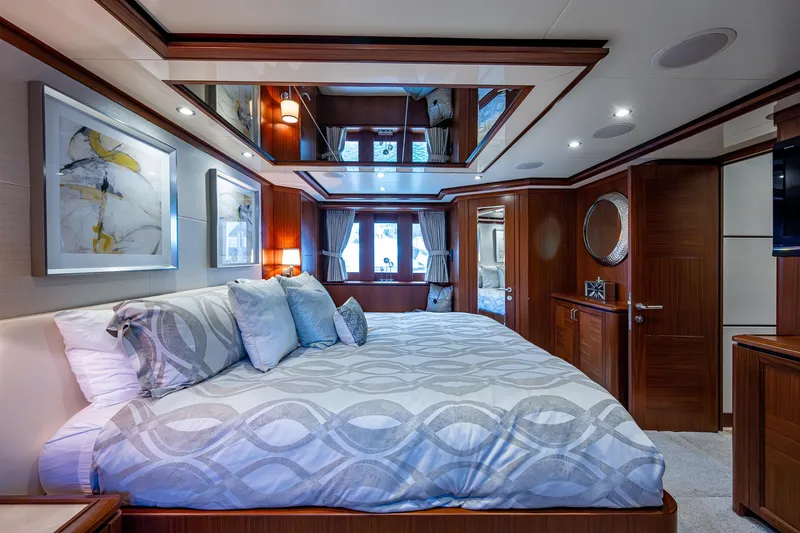 Uncorked Yacht Photos Pics Luxurious bedroom interior of 2011 Ocean Alexander 85E yacht with elegant decor and spacious layout.