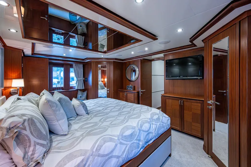 Uncorked Yacht Photos Pics Luxurious bedroom interior of 2011 Ocean Alexander 85E yacht with elegant wood finishes.