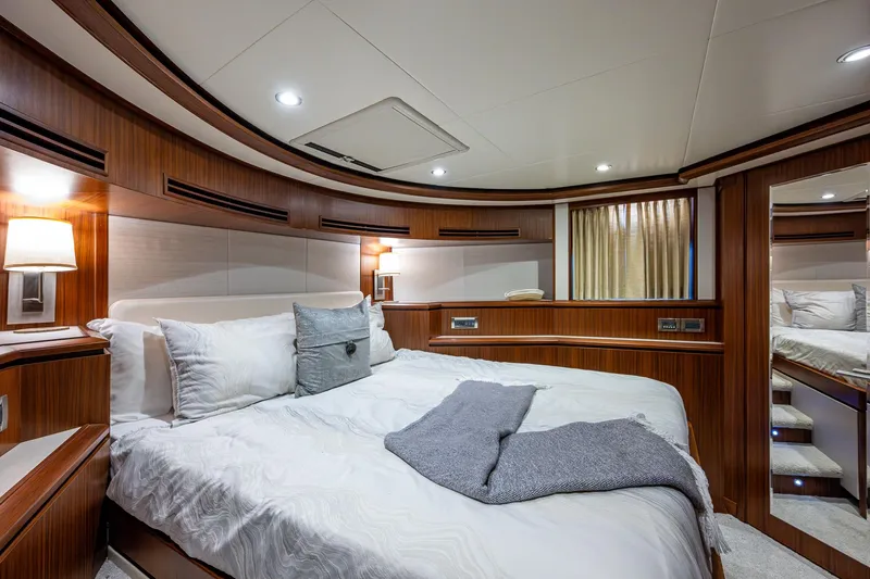 Uncorked Yacht Photos Pics Luxurious bedroom interior of 2011 Ocean Alexander 85E yacht with elegant wood paneling.