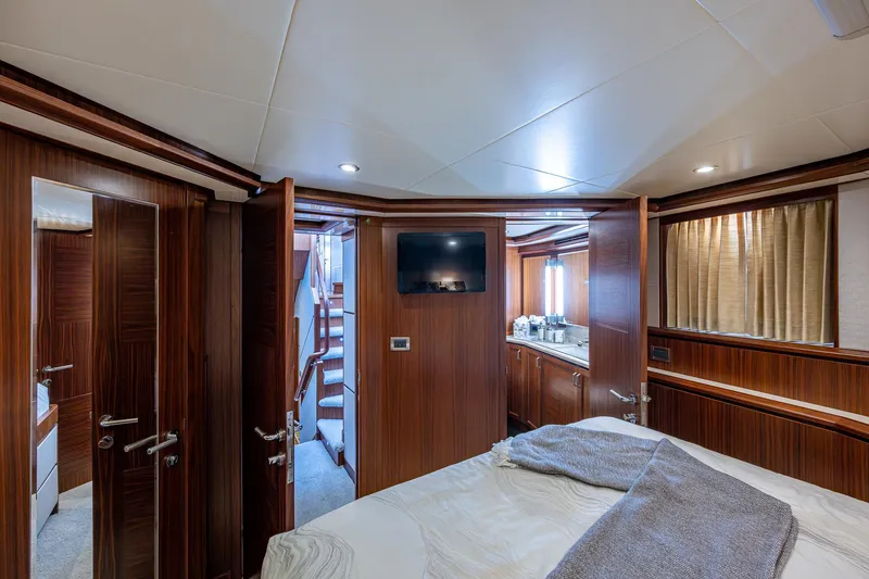 Uncorked Yacht Photos Pics Luxurious cabin interior of 2011 Ocean Alexander 85E yacht with wood paneling and modern amenities.