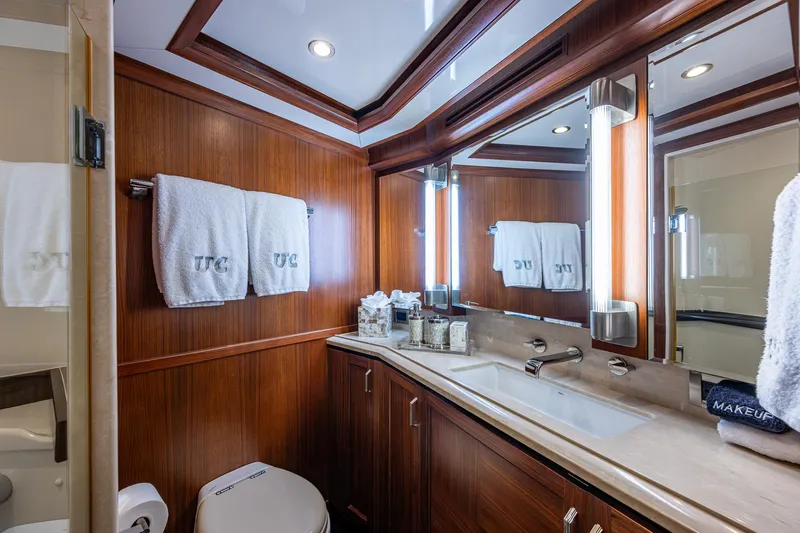 Uncorked Yacht Photos Pics Luxurious bathroom in 2011 Ocean Alexander 85E yacht with wood paneling and elegant fixtures.