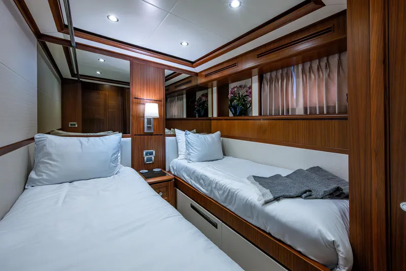 Uncorked Yacht Photos Pics Luxurious twin cabin interior of 2011 Ocean Alexander 85E yacht, featuring elegant wood paneling.