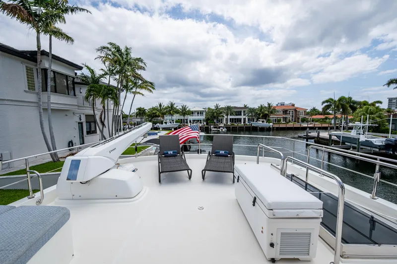 Uncorked Yacht Photos Pics Deck of 2011 Ocean Alexander 85E yacht with chairs and American flag.