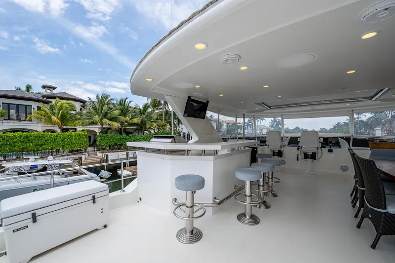 Uncorked Yacht Photos Pics Luxurious 2011 Ocean Alexander 85E yacht deck with bar stools and seating area.