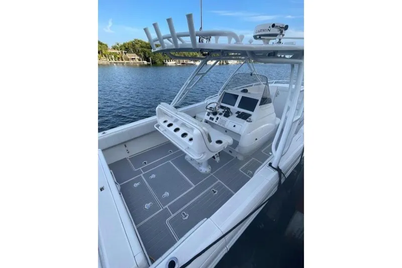  Yacht Photos Pics 2014 Intrepid 327 Cuddy boat with modern helm, docked on calm water.