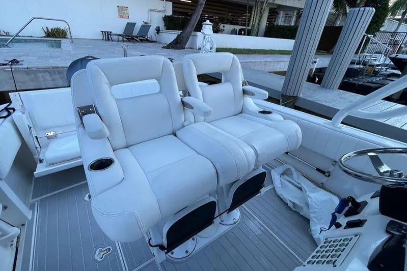  Yacht Photos Pics 2014 Intrepid 327 Cuddy boat with white cushioned seating and modern design.