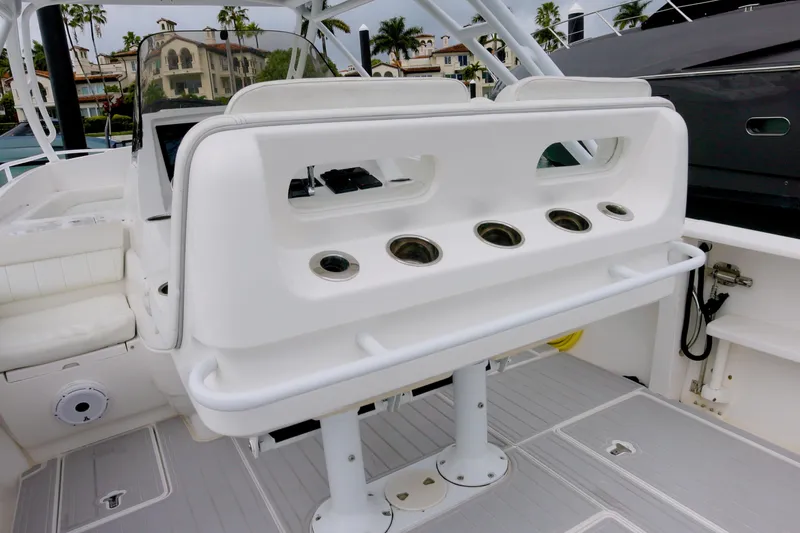  Yacht Photos Pics 2014 Intrepid 327 Cuddy boat interior with seating and rod holders.