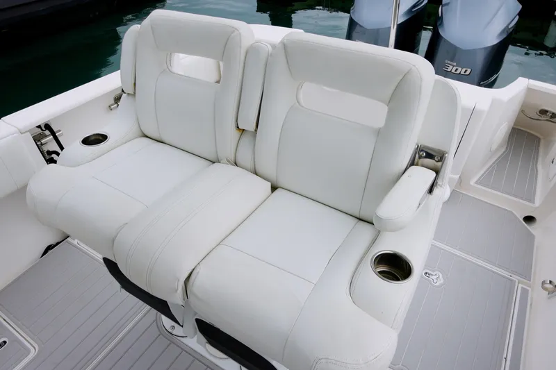  Yacht Photos Pics White leather seating on 2014 Intrepid 327 Cuddy boat with cup holders.