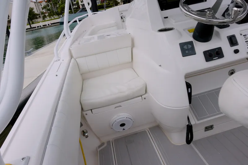  Yacht Photos Pics 2014 Intrepid 327 Cuddy boat interior with white seating and steering console.