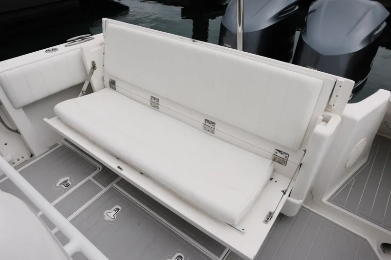  Yacht Photos Pics 2014 Intrepid 327 Cuddy boat with white cushioned seating and dual outboard motors.