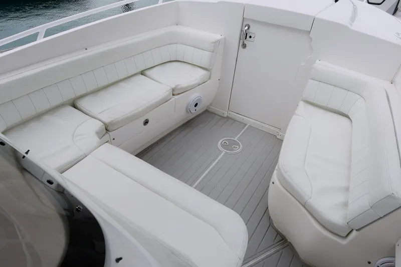  Yacht Photos Pics 2014 Intrepid 327 Cuddy boat interior with white cushioned seating.