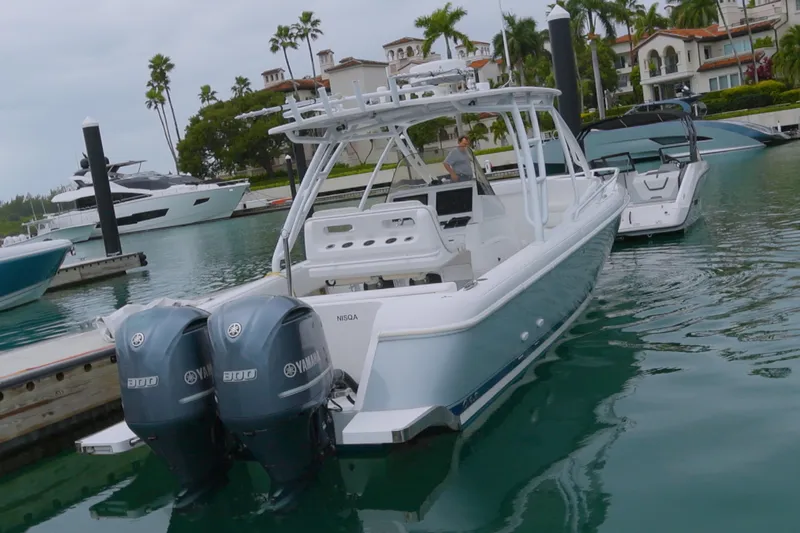  Yacht Photos Pics 2014 Intrepid 327 Cuddy boat docked with twin Yamaha engines in a marina.