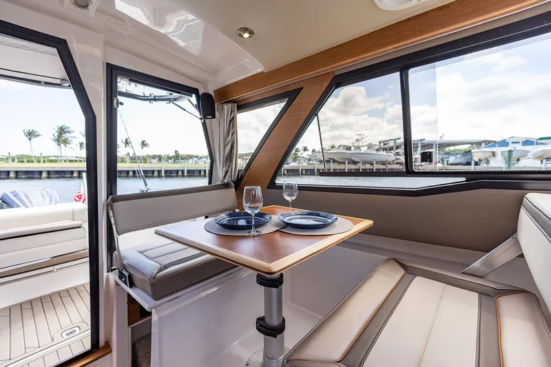  Yacht Photos Pics Manufacturer Provided Image: Interior of 2022 Cutwater C-248 Coupe with dining area and waterfront view.