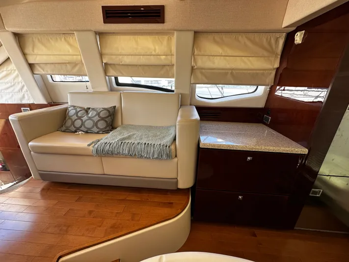 Incentive Yacht Photos Pics Luxurious interior of 2008 Sea Ray 47 Sedan Bridge yacht with sofa and wooden flooring.