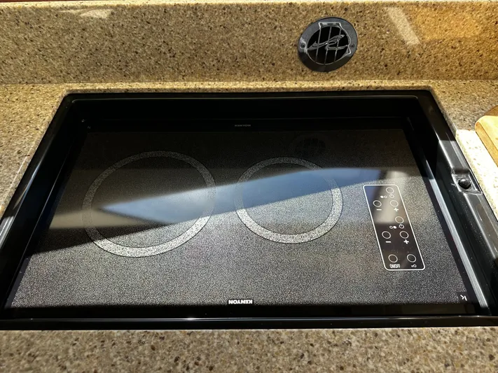 Incentive Yacht Photos Pics Built-in cooktop on 2008 Sea Ray 47 Sedan Bridge yacht, featuring two burners and control panel.