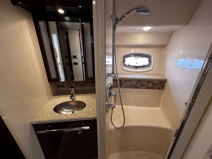Incentive Yacht Photos Pics 2008 Sea Ray 47 Sedan Bridge bathroom with shower, sink, and porthole window.